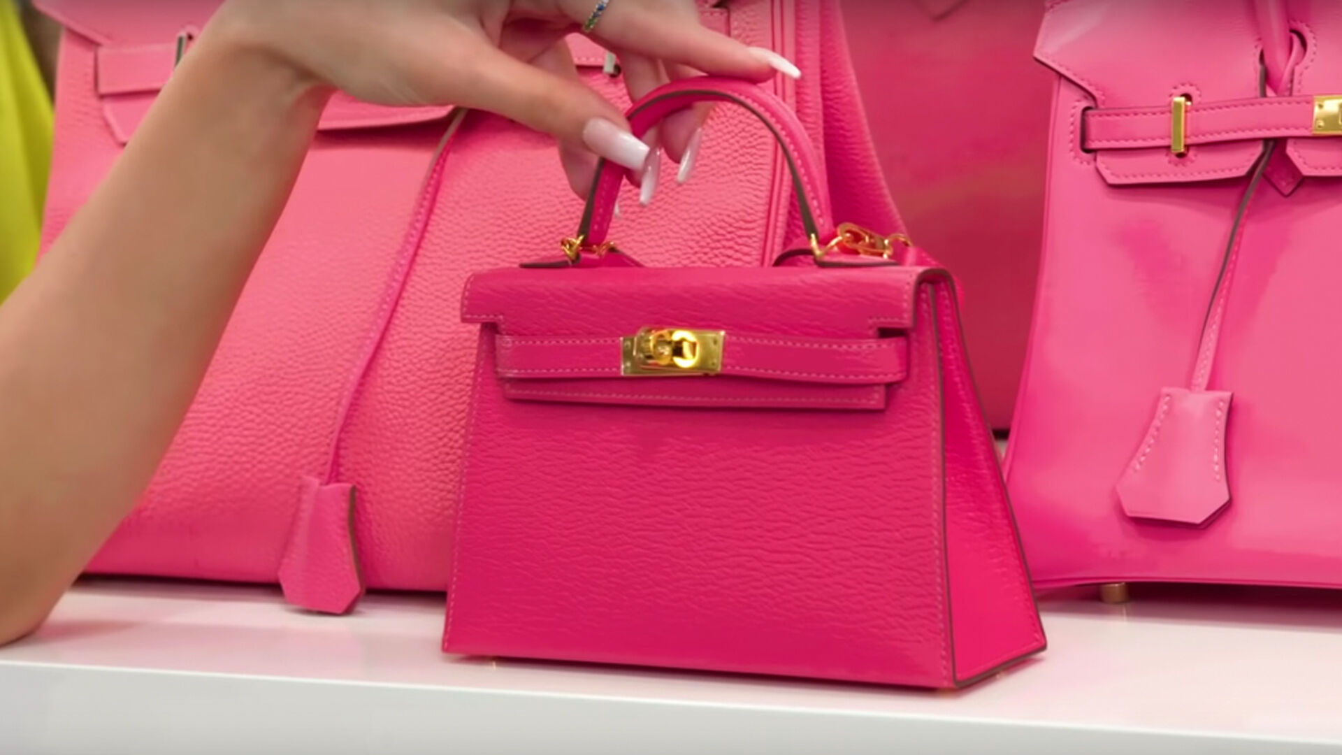 Who made Kylie Jenner's pink handbag, print scarf, bucket hat
