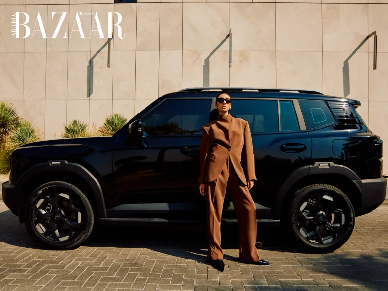 Yasmine Sima standing in front of Jetour T1